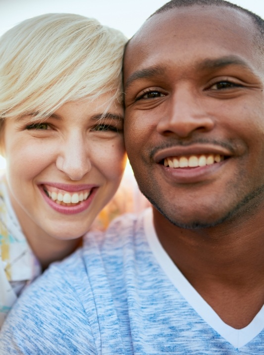 Man and woman smiling together outdoors