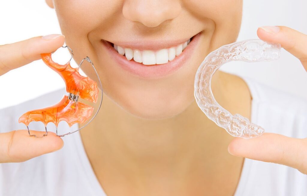 A girl holding two retainers